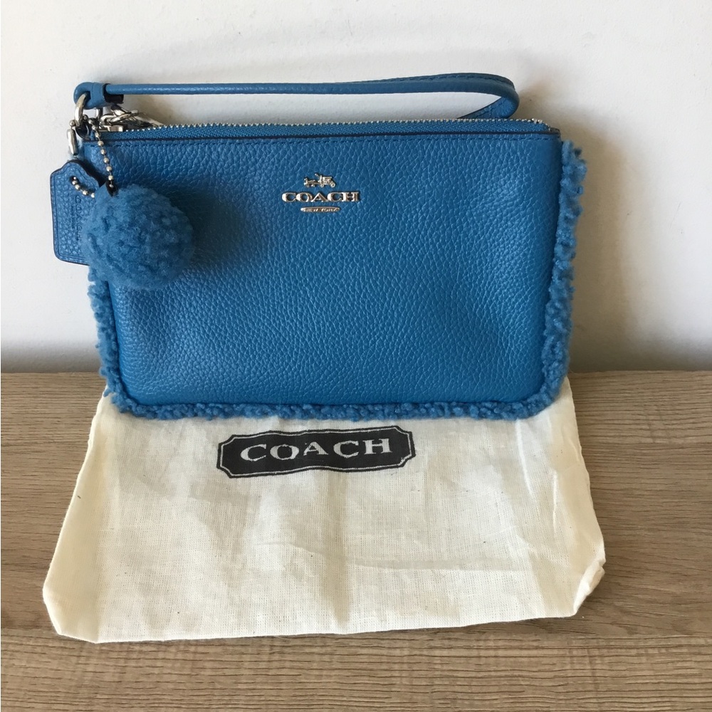 Coach Blue Pebbled Leather Wristlet with Pom Pom and shearling trim